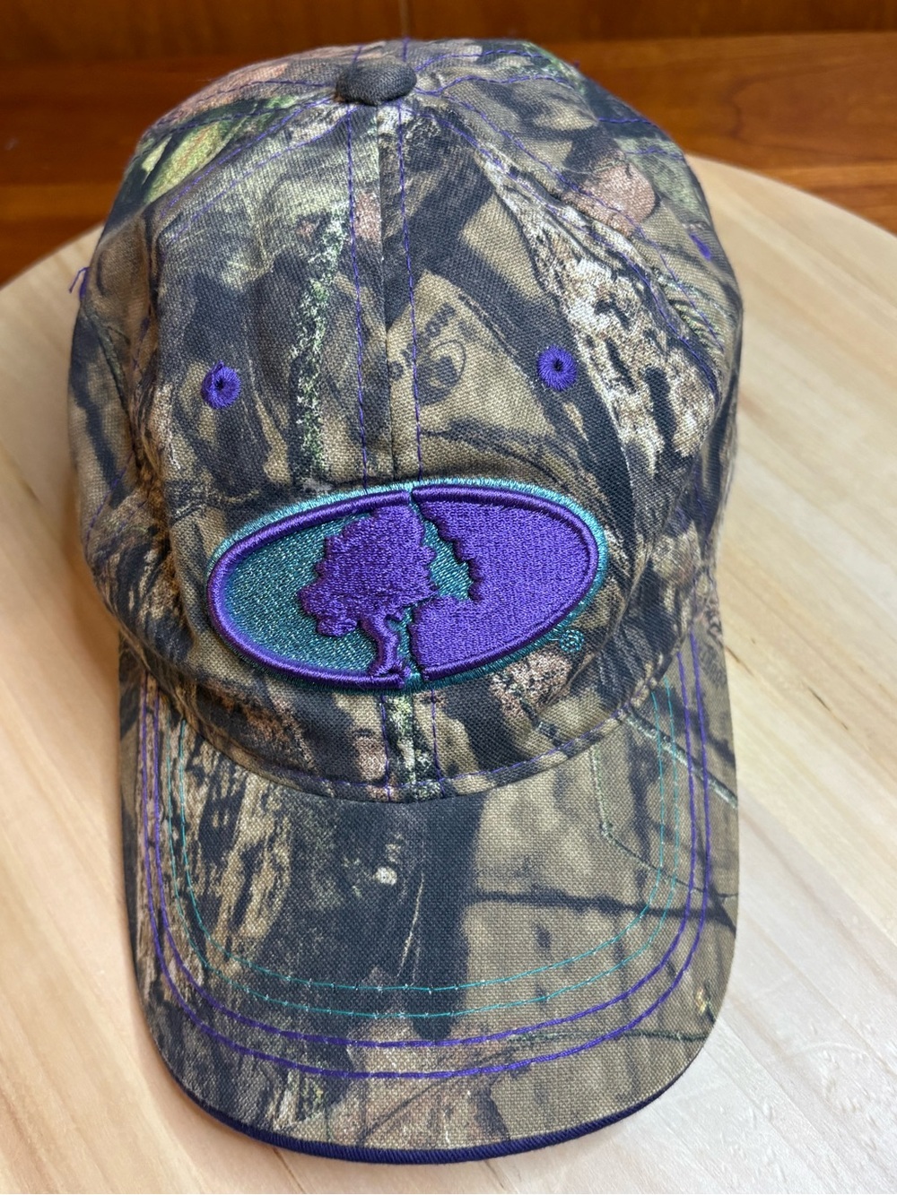 Mossy Oak camouflage baseball cap featuring a woodland camo pattern